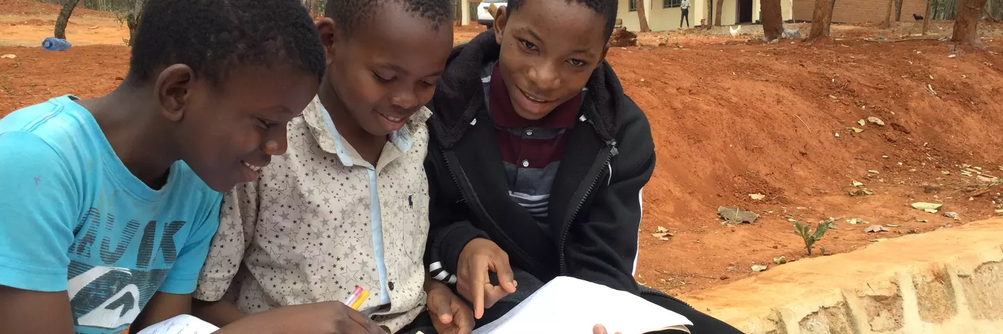 Three students at the newly opened St. Mauritius School study together