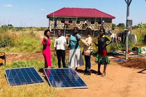 Students at the Light of Hope vocational school in front of the new solar system