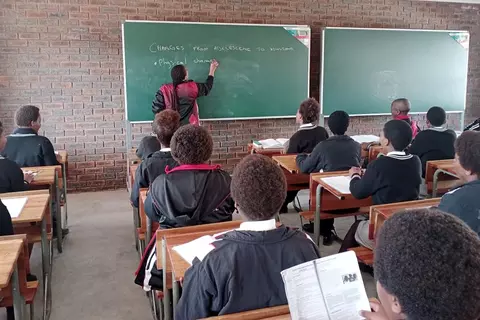 Teaching in one of the six newly constructed classrooms at Ekuphumleni Secondary School in South Africa.