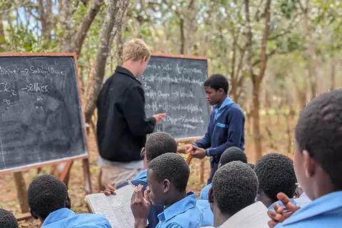 A German volunteer teaching chemistry at a secondary school in Malawi