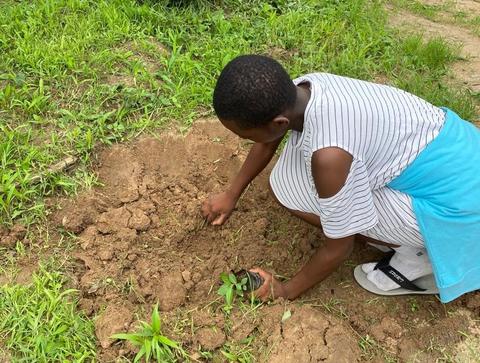 A student at St. Ignatius Secondary School at a tree-planting event