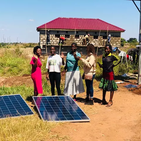 Students at the Light of Hope vocational school in front of the new solar system