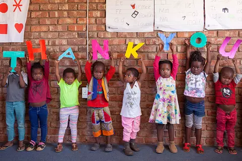Small children holding letters of Thank You