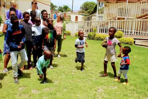 Montse is playing with kids in the afternoon.